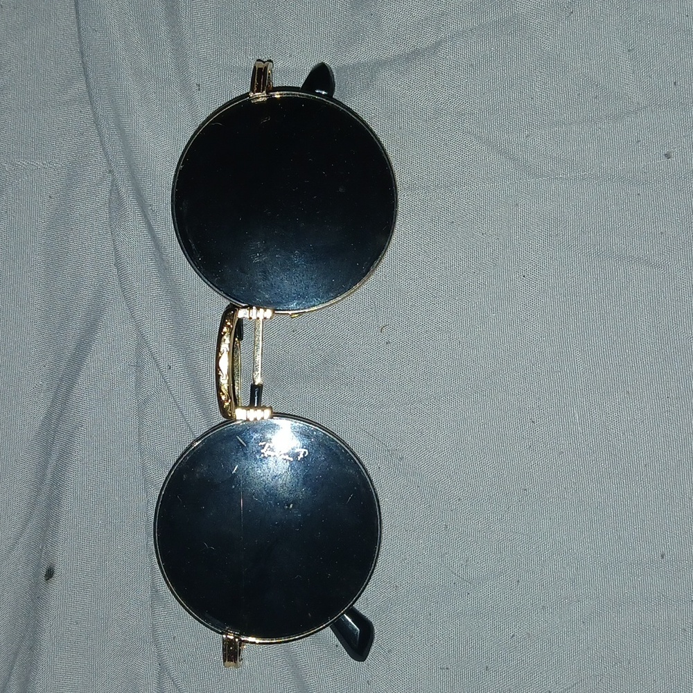 Circular sunglasses with gold frames. Unbranded.